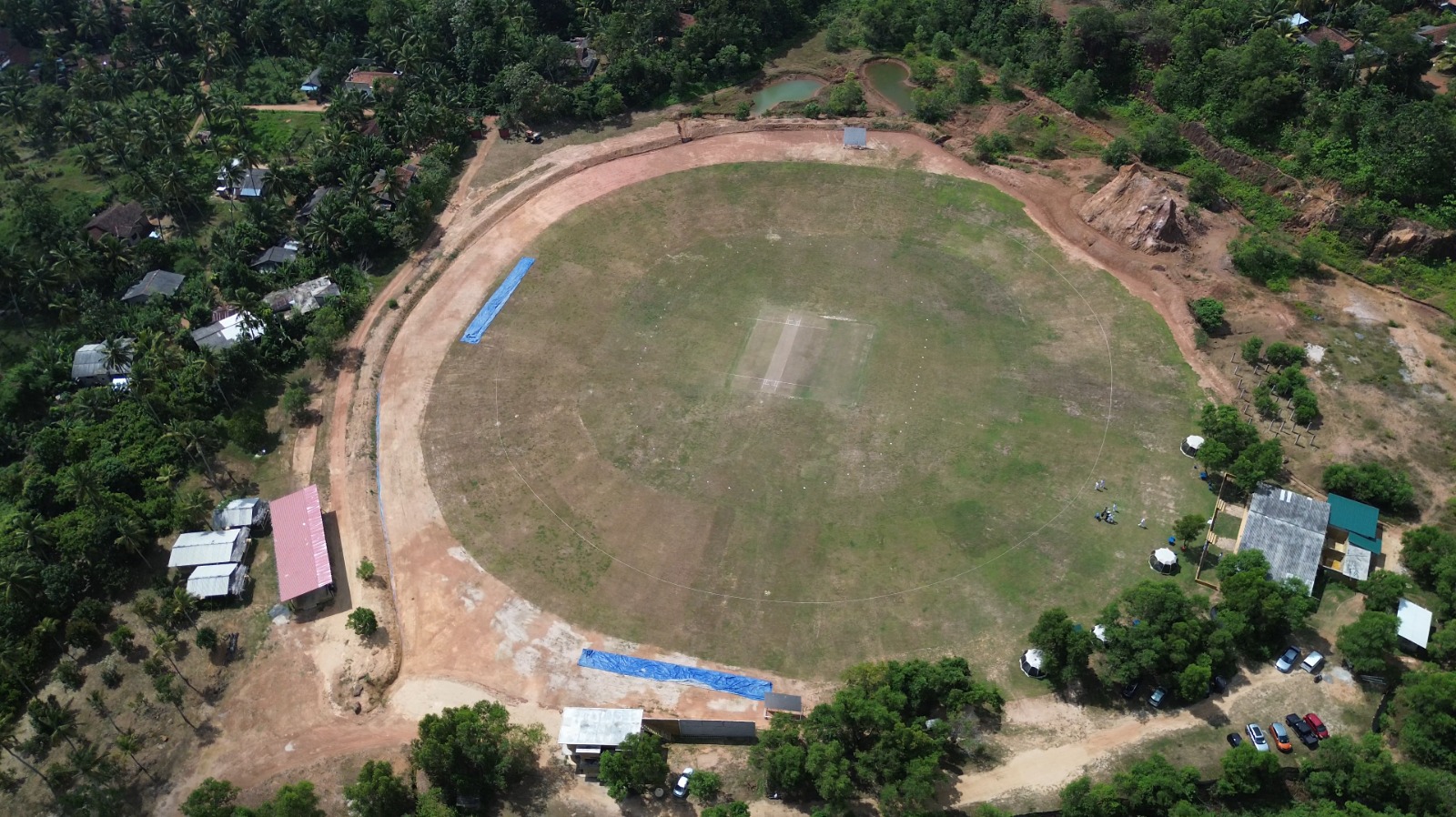 Angled drone view over the pitch & pavilions at DHH Turf Cricket Grounds Negombo Sri Lanka