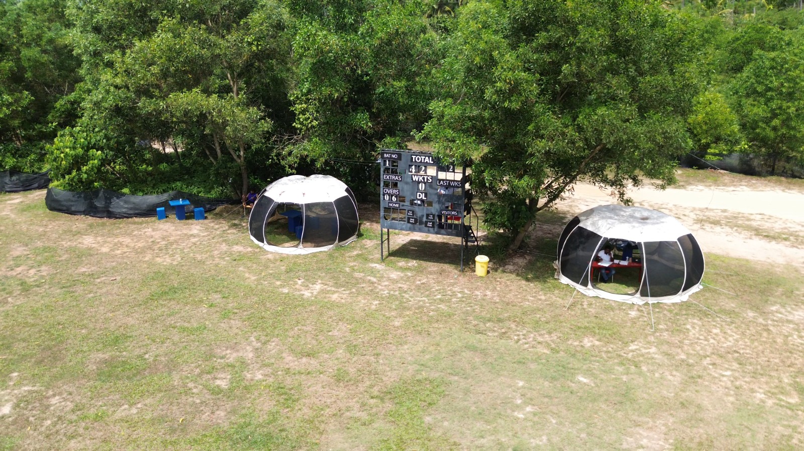 Scoreboard & scorers' tents under the trees - DHH Turf Cricket Grounds Negombo Sri Lanka